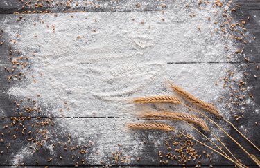 Baking concept on wood background, sprinkled flour with copy space