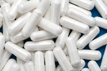 Pile of white capsules.