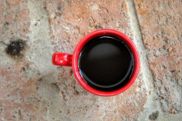 Directly Above Shot Of Black Coffee In Red Cup