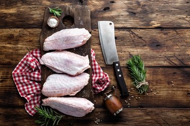 Raw turkey wings on wooden background top view, copy space, flat lay