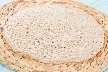 Close up of a tan injera sponge texture