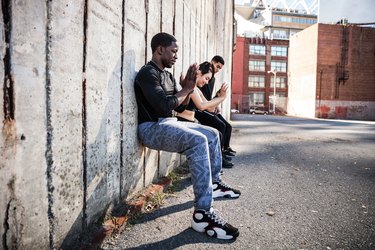 Wall sitting exercise urban outdoor gym in NYC