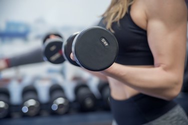 Gym woman Exercising with barbells