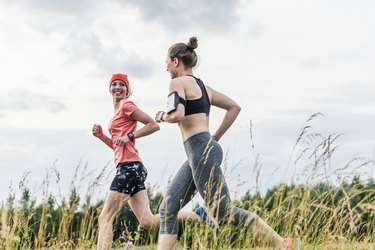 Two women running in the countryside