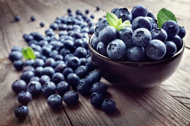 resveratrol-rich blueberries in bowl and scattered on table