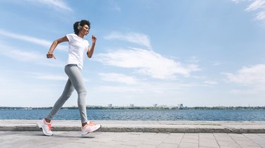 Afro Girl Running Alone Outdoor Along River Bank