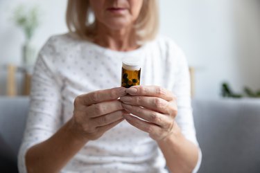 Woman skeptically looking at supplement