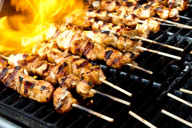 Chicken kabobs on a flaming grill