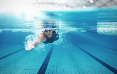 Swimmer racing in pool