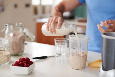 Post Workout Meals Close Up Of Man Making Protein Shake After Exercise At Home