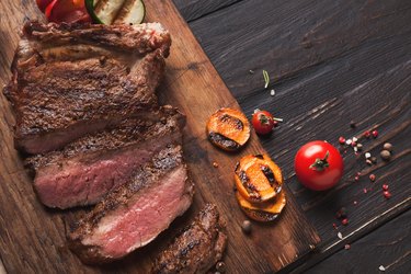 Grilled meat and vegetables on rustic wooden table