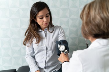 Doctor Examining Patient With Sphygmomanometer