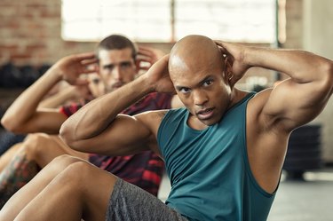 Men doing sit ups during a workout class