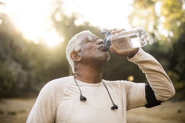 Senior African American Man Drinking Water to stay regular