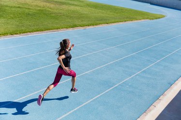 Runner sprinting towards success on running track