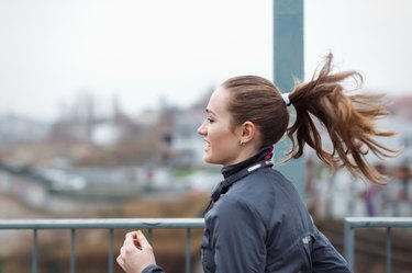 a sporty young woman runs through the city