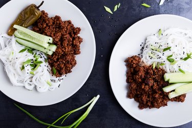 Asian style dish with ground beef, rice noodles, cucumbers, green onions and sesame seeds