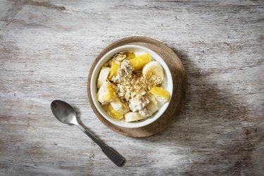 Bowl of granola with oat flakes, natural yoghurt, ananas and banana