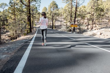 Woman jogging on the mountain road