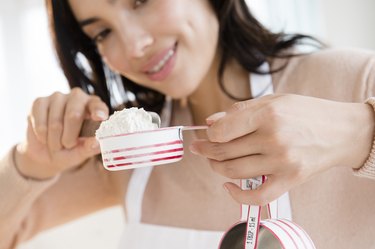 Hispanic woman measuring flour substitutes