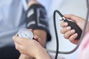 nurse measuring a patient's blood pressure