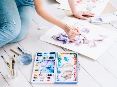 art therapy woman sitting painting watercolor