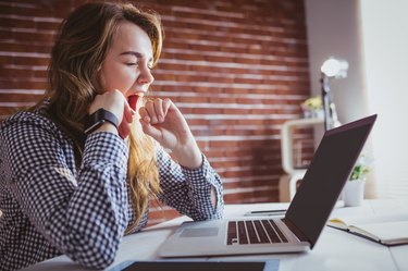 Young hipster businesswoman yawning