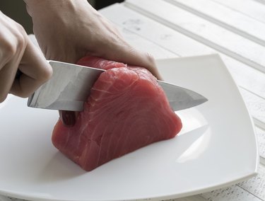 Yellow Fin Tuna being cut up for cooking. Tuna Fish.