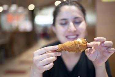 Young woman with fried chicken