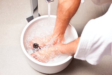 a person soaking their feet in epsom salt bath to treat ingrown toenail