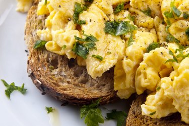 protein-rich scrambled egg with whole grain toast on white plate