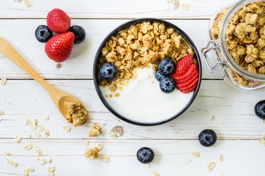 Directly Above Shot Of yogurt bowl with granola and fruit On Table