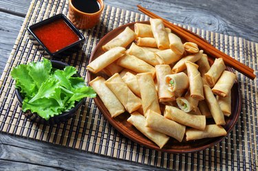 deep fried crispy bite-sized chinese spring rolls with cabbage, carrots and green peas fillings