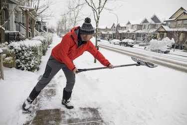 Man shoveling snow in winter and burning calories