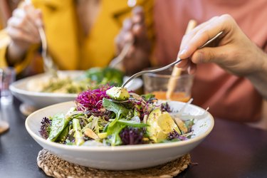 Close-up of people having healthy lunch in a restaurant