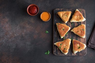 fried vegetarian samosa with sauces