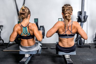 Women exercising on rowing machine