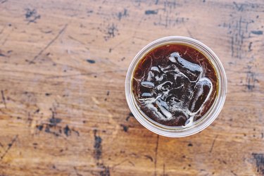 Directly Above Shot Of Cola In Glass On Wooden Table