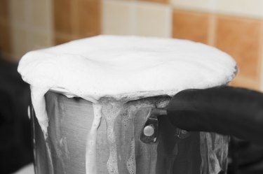 Milk boiling over a pan