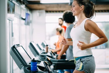 Group of friends exercising on treadmill machine