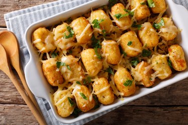 Baked Tater Tots with ground beef, corn and cheese close-up. horizontal top view