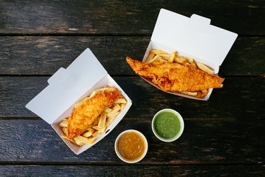 Fish and chips on a wooden table