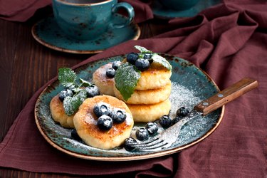 a plate of cottage cheese pancakes with blueberries