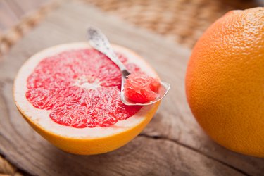 Half of a grapefruit on a wooden background