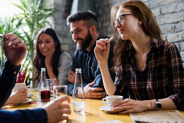 Happy young friends hangout in coffee shop