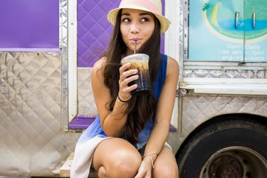 Woman cutting 300 calories by drinking an iced coffee rather than a Frappuccino