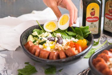Mediterranean-Inspired Farro Breakfast Bowl with eggs sausage and veggies.