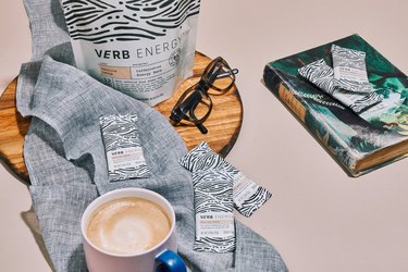 verb energy bars on table with coffee, book and glasses