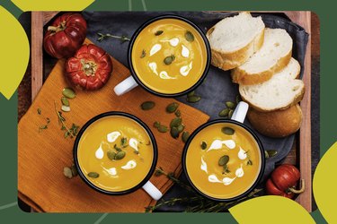 overhead photo of three mugs of soup with slices of bread and pumpkins and pumpkin seeds