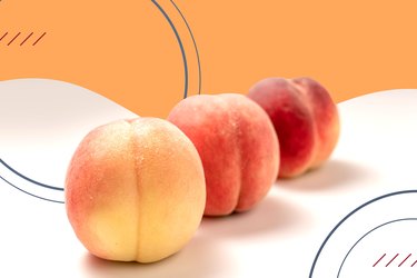 Three peaches on an orange and white background